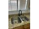 Close-up of stainless steel double-bowl kitchen sink, black faucet and granite countertop at 1040 W Juniper Ave, Gilbert, AZ 85233