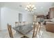 Elegant dining area with a stylish chandelier and seamless flow to the modern kitchen at 10609 E Durant Dr, Mesa, AZ 85212