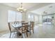 Well-lit dining area with an open layout, leading to the living room and outdoor patio at 10609 E Durant Dr, Mesa, AZ 85212