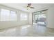 Bright living room with neutral tile, a ceiling fan, and a sliding glass door to the patio at 10609 E Durant Dr, Mesa, AZ 85212