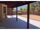 Covered patio overlooks a large backyard with mature trees and desert landscaping at 1156 E Vinedo Ln, Tempe, AZ 85284