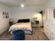 Modern bedroom with a white comforter and a ceiling fan at 1156 E Vinedo Ln, Tempe, AZ 85284