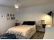 Modern bedroom with a white comforter and decor on the wall at 1156 E Vinedo Ln, Tempe, AZ 85284