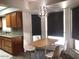 Sunlit dining area features a modern pendant light, wood table, and modern chairs at 1156 E Vinedo Ln, Tempe, AZ 85284