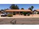 Single story home with a low maintenance desert rock front yard and an attached garage at 1156 E Vinedo Ln, Tempe, AZ 85284