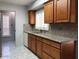 Well-lit kitchen with wood cabinets, granite countertops, and white flooring at 1156 E Vinedo Ln, Tempe, AZ 85284