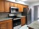 Updated kitchen features stainless steel appliances, granite counters, and cabinetry at 1156 E Vinedo Ln, Tempe, AZ 85284