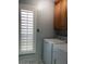 Laundry room with top load washer and dryer with wood cabinetry and window blinds at 1156 E Vinedo Ln, Tempe, AZ 85284