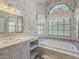 Bathroom featuring a soaking tub, windows, decorative wallpaper, and a single sink vanity at 13064 N 100Th Pl, Scottsdale, AZ 85260