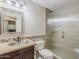 Bathroom featuring a single sink vanity with stone countertops, a decorative mirror, and a glass enclosed shower at 13064 N 100Th Pl, Scottsdale, AZ 85260