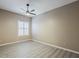 Neutral bedroom with laminate flooring, a ceiling fan, and a window with plantation shutters at 13064 N 100Th Pl, Scottsdale, AZ 85260