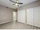 Spacious bedroom featuring hardwood floors, a ceiling fan, and a large closet with bi-fold doors at 13064 N 100Th Pl, Scottsdale, AZ 85260