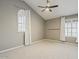 Bright bedroom with vaulted ceiling, windows, and plush carpet at 13064 N 100Th Pl, Scottsdale, AZ 85260
