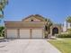 Spacious home with a three-car garage, mature landscaping, and a well-manicured lawn for great curb appeal at 13064 N 100Th Pl, Scottsdale, AZ 85260