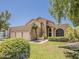 Stunning home featuring a lush lawn, mature landscaping, and a convenient three-car garage, combining elegance and functionality at 13064 N 100Th Pl, Scottsdale, AZ 85260