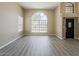 Bright living room featuring wood-look floors, large windows, and neutral walls providing a versatile space for relaxation at 13064 N 100Th Pl, Scottsdale, AZ 85260