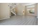 Spacious living room with wood-look floors, a soaring ceiling, a staircase, and large windows offering abundant natural light at 13064 N 100Th Pl, Scottsdale, AZ 85260