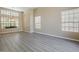 Open living room featuring beautiful wood-look floors, ample natural light, and neutral walls for versatile decorating at 13064 N 100Th Pl, Scottsdale, AZ 85260
