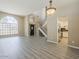 Expansive living room featuring wood-look floors, large windows, and an open layout that seamlessly connects to the kitchen at 13064 N 100Th Pl, Scottsdale, AZ 85260