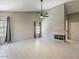 Open living room with fireplace, ceiling fan, tile floors, vaulted ceilings, and lots of natural light at 13064 N 100Th Pl, Scottsdale, AZ 85260