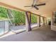 Covered patio area featuring a ceiling fan, and decorative curtains with a pool view at 13064 N 100Th Pl, Scottsdale, AZ 85260