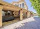 An expansive covered patio, featuring brick floors and access to the pool and backyard at 13064 N 100Th Pl, Scottsdale, AZ 85260