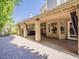 Spacious covered patio featuring brick floors, with views of the backyard at 13064 N 100Th Pl, Scottsdale, AZ 85260