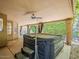 Covered patio featuring a hot tub and overlooking the lush backyard at 13064 N 100Th Pl, Scottsdale, AZ 85260