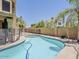 Refreshing backyard pool with stylish stone border, mature landscaping, and privacy fence at 13064 N 100Th Pl, Scottsdale, AZ 85260