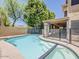Sparkling pool and spa area surrounded by secure fencing and a covered patio at 13064 N 100Th Pl, Scottsdale, AZ 85260