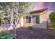 Exterior view of the home with desert landscaping, a covered patio, and a glimpse of the sunset sky at 13448 W Miner Trl, Peoria, AZ 85383
