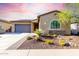Charming single-story home features desert landscaping, a stone facade, a tile roof, and a two-car garage at 13448 W Miner Trl, Peoria, AZ 85383