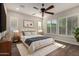 Bright main bedroom features plantation shutters, ceiling fan, and plush carpeting at 13448 W Miner Trl, Peoria, AZ 85383