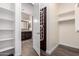 Hallway view into a spacious walk-in closet with vanity and full bath at 13448 W Miner Trl, Peoria, AZ 85383