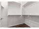 Spacious walk-in closet features chrome hanging racks and hardwood-style flooring at 13448 W Miner Trl, Peoria, AZ 85383