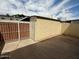 Fenced backyard with a detached storage unit and a metal gate at 1385 N 44Th St, Phoenix, AZ 85008