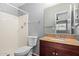 Bathroom includes a shower, toilet, granite countertop, wood vanity, and a mirror at 1385 N 44Th St, Phoenix, AZ 85008