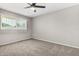 Bedroom with carpet flooring, a ceiling fan, and a window allowing natural light at 1385 N 44Th St, Phoenix, AZ 85008