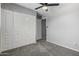Neutral bedroom featuring a ceiling fan, carpet floors, and closet with white doors at 1385 N 44Th St, Phoenix, AZ 85008