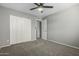 Bedroom featuring carpet flooring, a ceiling fan, a window, and closet space at 1385 N 44Th St, Phoenix, AZ 85008