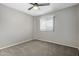 Bedroom with carpet flooring, a ceiling fan, and a window allowing natural light at 1385 N 44Th St, Phoenix, AZ 85008