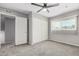 Bedroom featuring carpet flooring, a ceiling fan, a window, and closet space at 1385 N 44Th St, Phoenix, AZ 85008