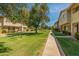 Well-manicured community with lush green lawns and mature shade trees at 1385 N 44Th St, Phoenix, AZ 85008