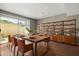 Dining area with large wooden table, leather chairs, hardwood floors, and bright natural light at 1385 N 44Th St, Phoenix, AZ 85008