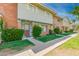 Townhome featuring brick accents, a front yard, and a wood door at 1385 N 44Th St, Phoenix, AZ 85008