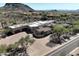 Aerial view of a luxury desert home showcasing a spacious driveway and a large three-car garage at 13931 E Via Linda --, Scottsdale, AZ 85259