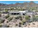 Back of estate features a pool and covered outdoor seating areas with scenic desert views at 13931 E Via Linda --, Scottsdale, AZ 85259
