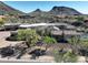 Elevated view of a sprawling desert home showcasing a pool, covered patio, and three-car garage at 13931 E Via Linda --, Scottsdale, AZ 85259
