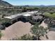 Aerial view of a desert estate boasting a three-car garage, and circular driveway at 13931 E Via Linda --, Scottsdale, AZ 85259