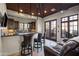 A spacious bar area with a dark countertop, seating, and convenient access to the outdoors at 13931 E Via Linda --, Scottsdale, AZ 85259